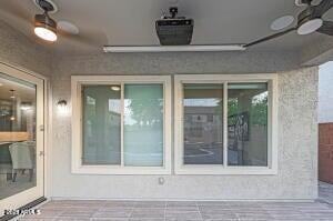 exterior space featuring a ceiling fan
