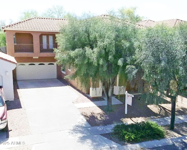 view of front of house with a garage and a balcony