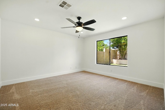 empty room featuring baseboards, carpet floors, and visible vents