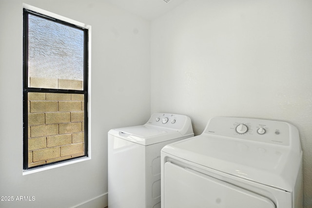 washroom featuring separate washer and dryer and laundry area