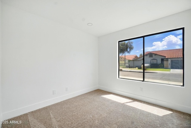 spare room with carpet floors and baseboards
