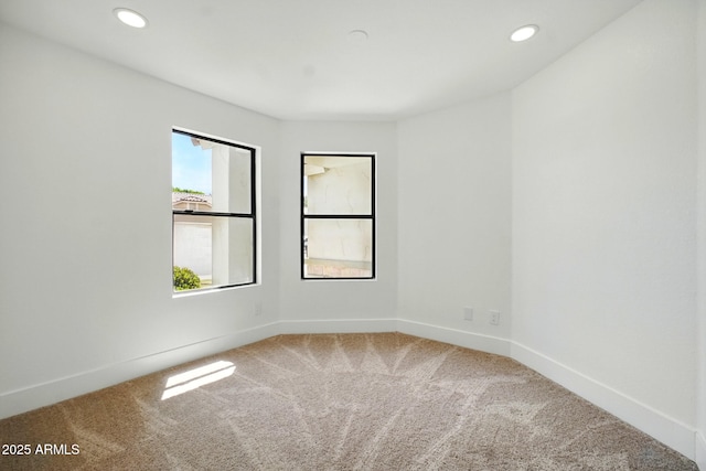unfurnished room featuring recessed lighting, carpet, and baseboards