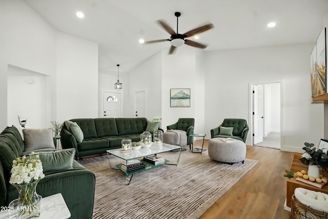 living area featuring high vaulted ceiling, wood finished floors, ceiling fan, baseboards, and recessed lighting