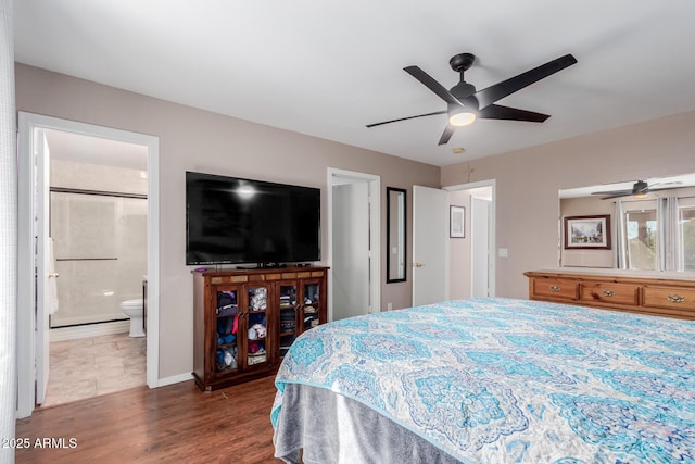 bedroom featuring dark wood-type flooring, ceiling fan, and ensuite bathroom