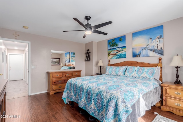 bedroom with dark hardwood / wood-style floors and ceiling fan