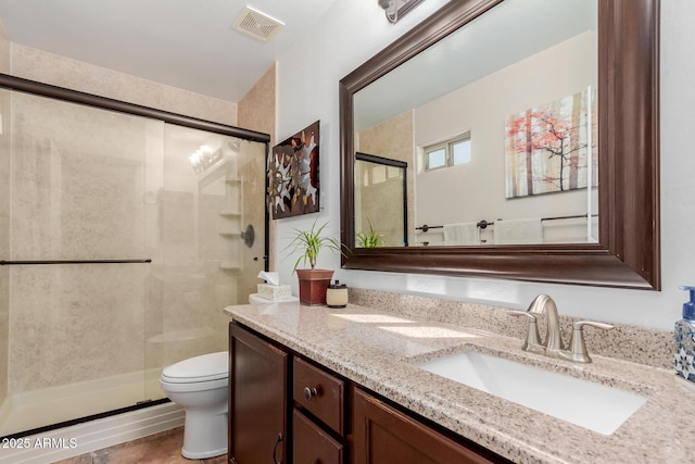 bathroom with vanity, toilet, and an enclosed shower