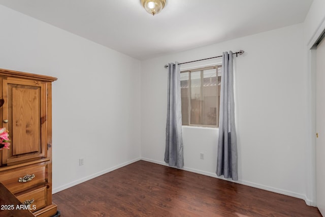 unfurnished bedroom featuring dark hardwood / wood-style floors