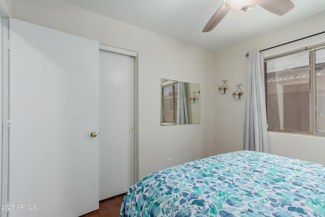 bedroom with ceiling fan, dark hardwood / wood-style flooring, and a closet