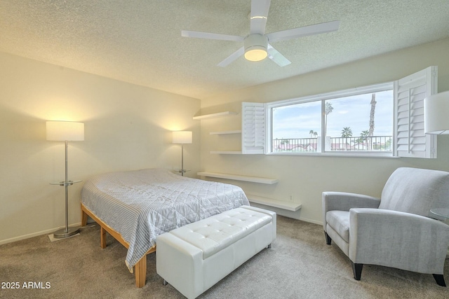 carpeted bedroom with ceiling fan, baseboards, and a textured ceiling