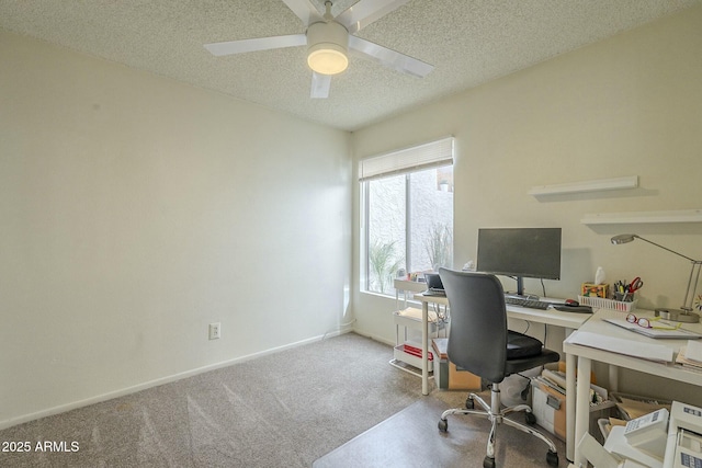 office area with a textured ceiling, carpet floors, a ceiling fan, and baseboards