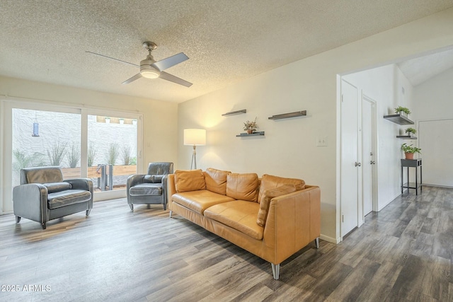 living room featuring a ceiling fan, a textured ceiling, and wood finished floors