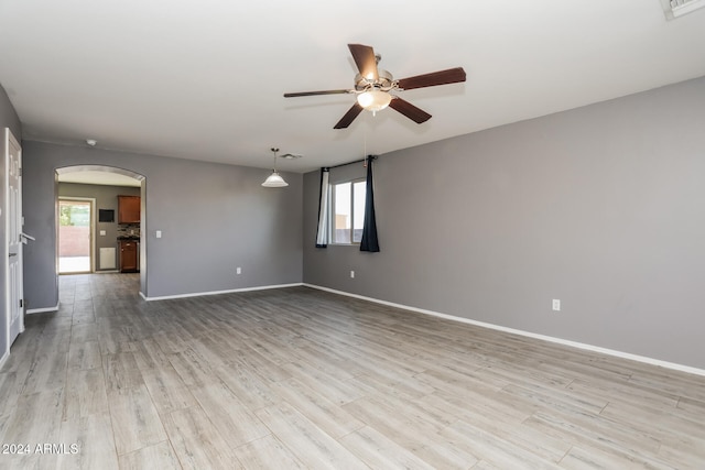 unfurnished room with ceiling fan and light hardwood / wood-style flooring