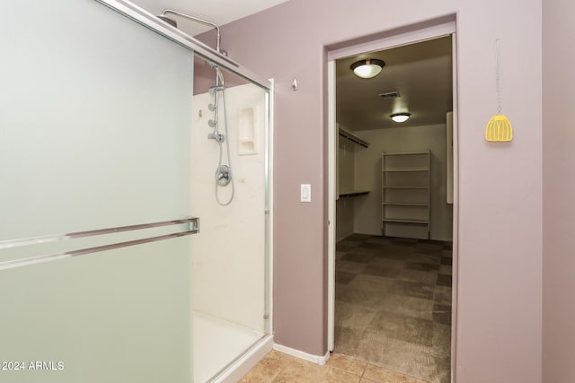 bathroom featuring tile patterned floors and an enclosed shower