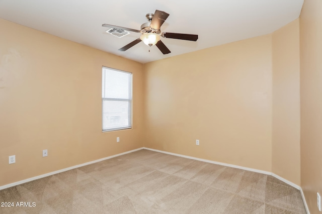 spare room with light carpet and ceiling fan