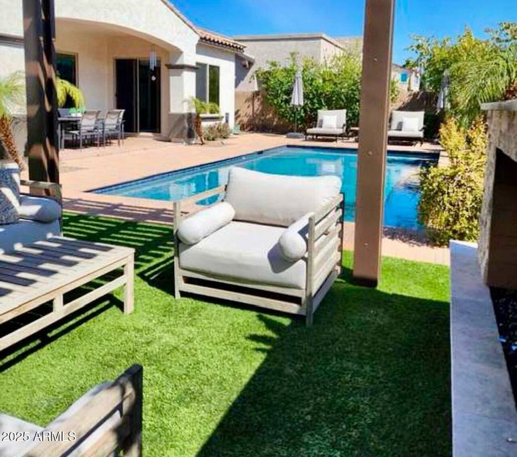 view of swimming pool with a lawn and a patio