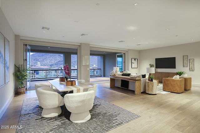 dining space featuring visible vents, a wealth of natural light, and light wood-style flooring