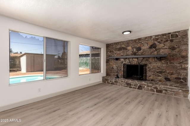 unfurnished living room with a fireplace and wood-type flooring