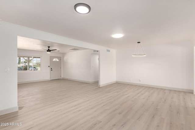 empty room featuring ceiling fan and light wood-type flooring