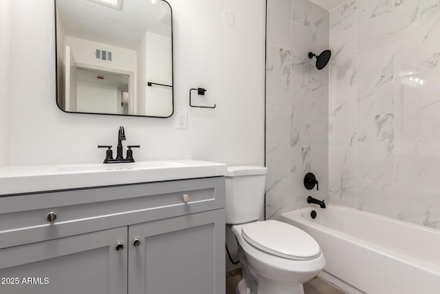 full bathroom with toilet, vanity, and tiled shower / bath