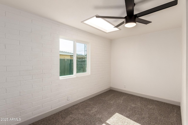 carpeted empty room featuring brick wall