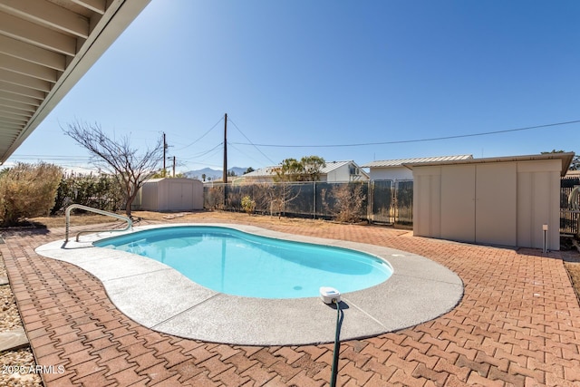 view of swimming pool with a shed and a patio