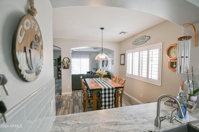 dining space with dark hardwood / wood-style flooring and sink