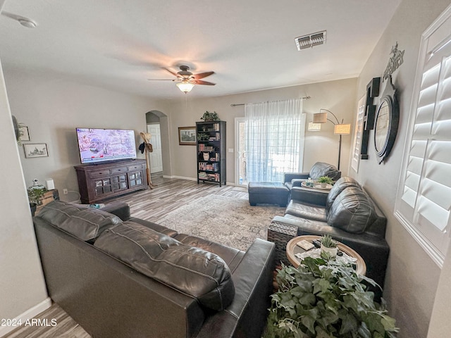 living room featuring hardwood / wood-style flooring and ceiling fan