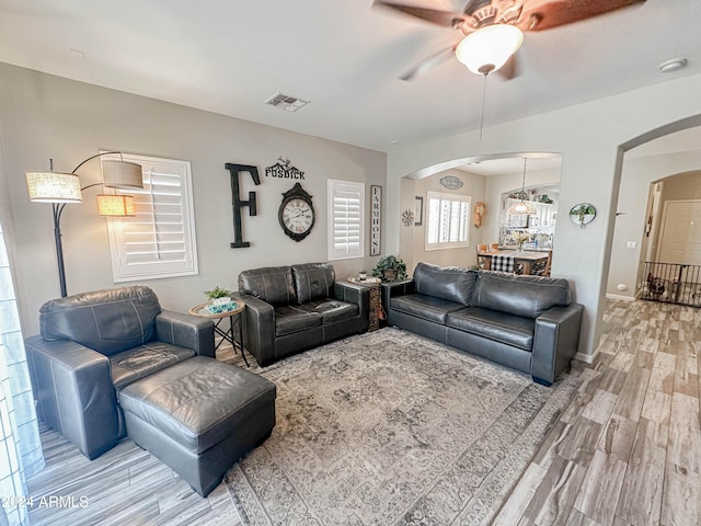 living room featuring wood-type flooring and ceiling fan