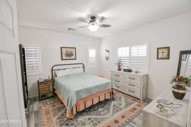 bedroom with hardwood / wood-style flooring and ceiling fan