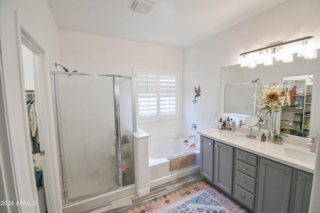 bathroom featuring vanity and shower with separate bathtub