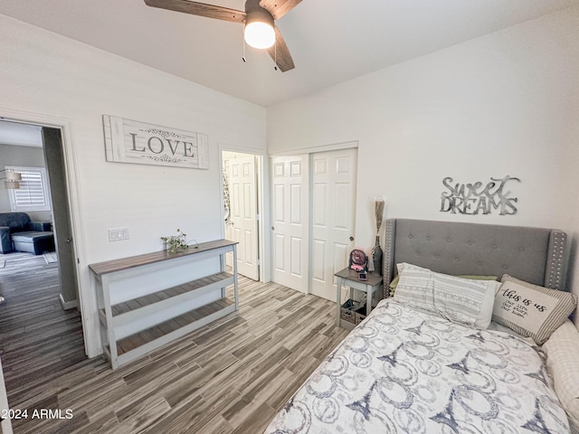 bedroom featuring hardwood / wood-style floors, a closet, and ceiling fan