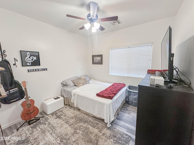 bedroom with ceiling fan and hardwood / wood-style floors