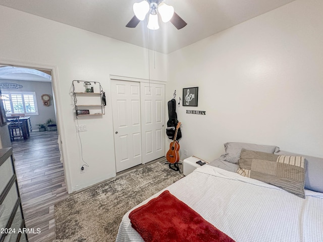 bedroom with hardwood / wood-style floors, a closet, and ceiling fan