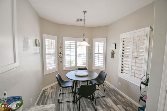 dining space featuring dark wood-type flooring