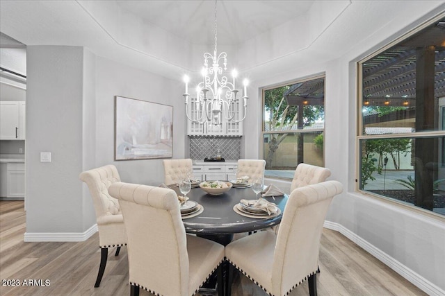 dining space featuring a chandelier and light wood-type flooring