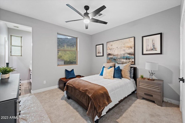 bedroom featuring light carpet and ceiling fan