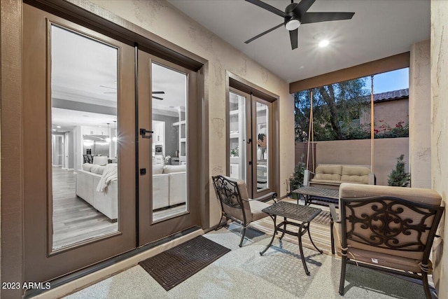 sunroom / solarium with ceiling fan and french doors