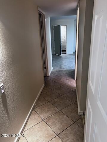 8055 E Thomas Rd Unit H103, Scottsdale, AZ 85251 - corridor with baseboards and tile patterned floors