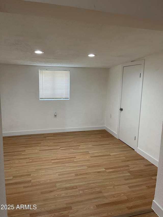 unfurnished room with light wood-type flooring