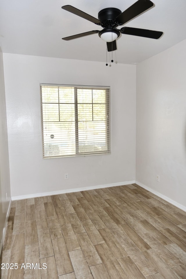 unfurnished room featuring baseboards, ceiling fan, and light wood finished floors