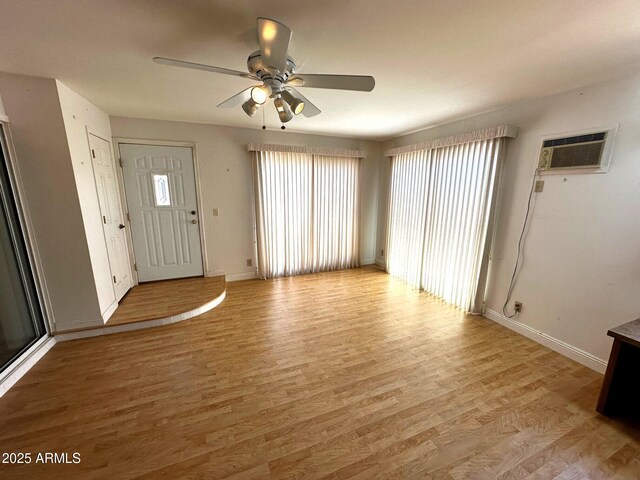 1836 N Stapley Dr Unit 88, Mesa, AZ 85203 - entryway with a ceiling fan, baseboards, light wood-style flooring, and an AC wall unit