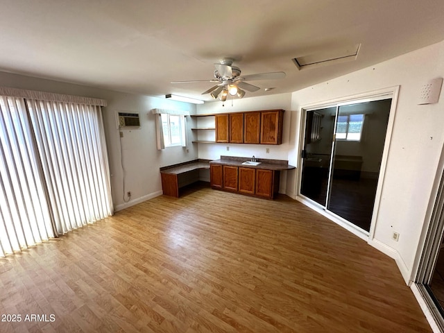 1836 N Stapley Dr Unit 88, Mesa, AZ 85203 - kitchen featuring brown cabinets, wood finished floors, a sink, and baseboards