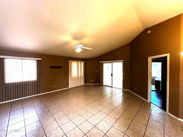 1836 N Stapley Dr Unit 88, Mesa, AZ 85203 - spare room featuring light tile patterned floors, vaulted ceiling, ceiling fan, and baseboards