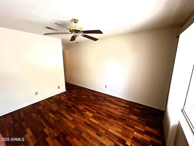 1836 N Stapley Dr Unit 88, Mesa, AZ 85203 - spare room featuring dark wood-style floors, ceiling fan, and baseboards