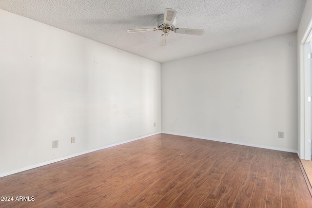 unfurnished room with wood-type flooring, a textured ceiling, and ceiling fan