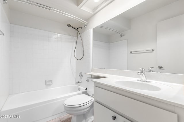 full bathroom featuring tile patterned flooring, vanity, tiled shower / bath combo, and toilet