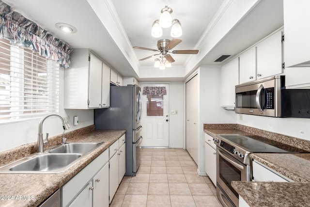 kitchen featuring white cabinets, crown molding, sink, and stainless steel appliances