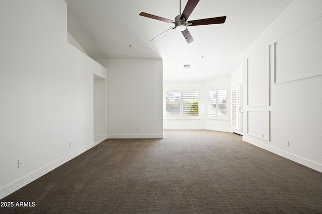 empty room with dark colored carpet, visible vents, baseboards, and a ceiling fan