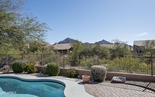 view of pool with a patio, a mountain view, a fenced backyard, and a fenced in pool