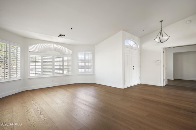 interior space with plenty of natural light, baseboards, and wood finished floors